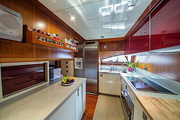 A kitchen with a stainless steel refrigerator and a microwave