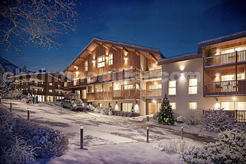 A cozy mountain village at night, covered in snow, with illuminated chalet-style buildings, a Christmas tree, a car, and people sledding.