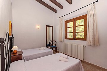 A bedroom with two twin beds and a radiator