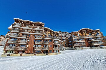 A snowy building with a blue sky in the background