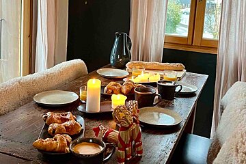 A table with plates of food and candles on it