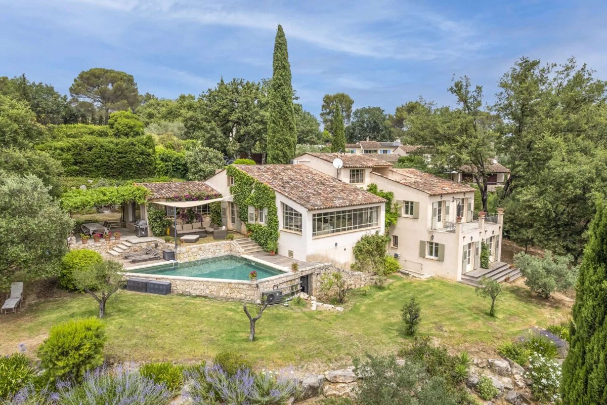 A large house with a large swimming pool in front of it
