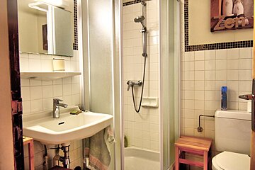 A bathroom with a sign on the wall that says zen