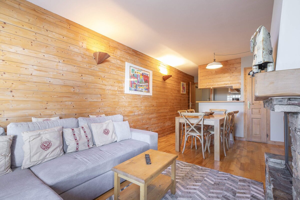 A living room with a couch and a table and chairs