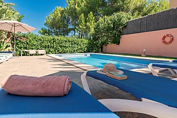 A pool with a life preserver on the side of it