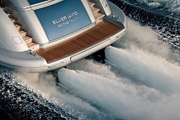 A silver wind george town boat is going through the water