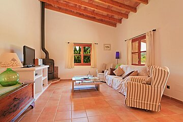 A living room with a couch and chairs and a television