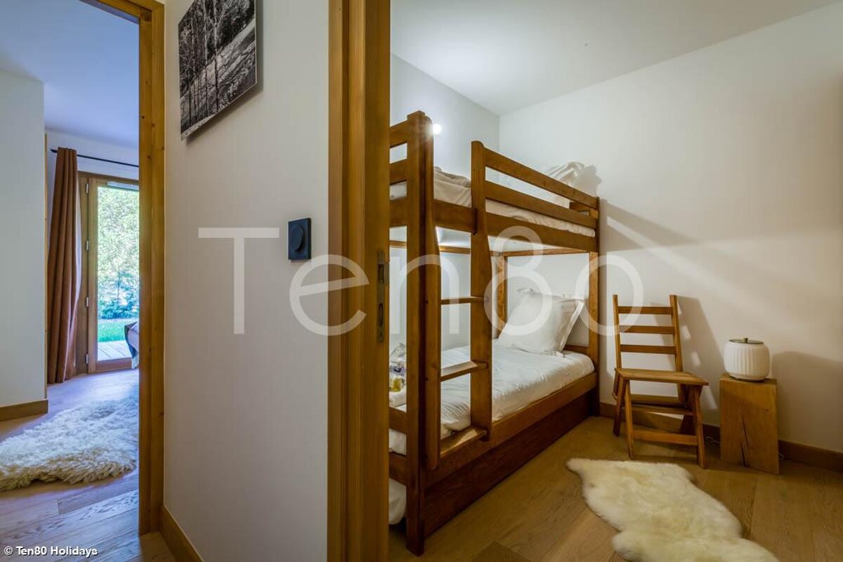A bedroom with a bunk bed and the word holidays on the wall