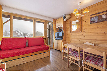 A living room with a couch a table and chairs
