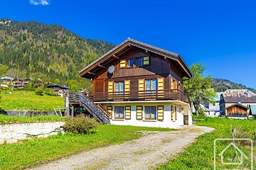 A house with a balcony and a satellite dish on the roof