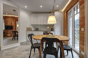 A kitchen with a table and chairs and a sign that says coffee