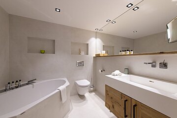 A bathroom with a bathtub a toilet and a sink