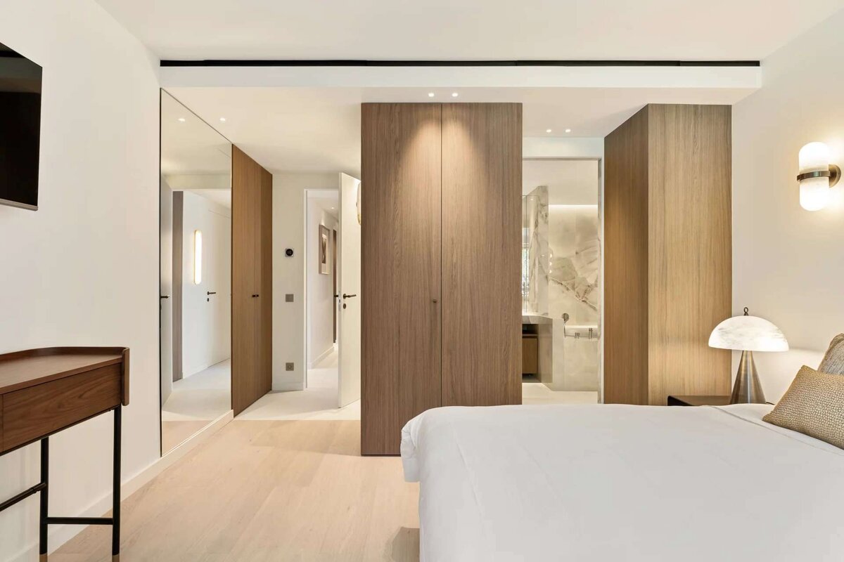 A bedroom with a large bed and a television