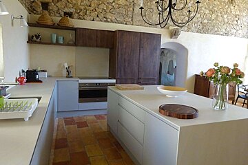 A kitchen with a cutting board on the counter