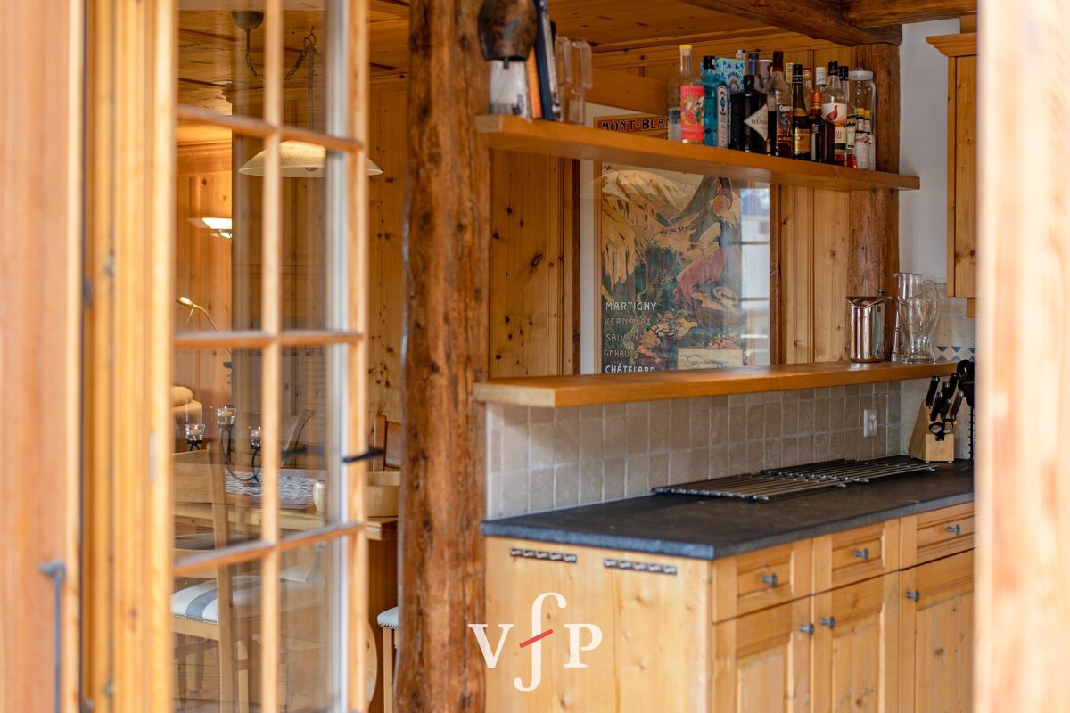 A wooden kitchen with a poster on the wall that says