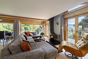 A living room with a couch a chair and a fireplace