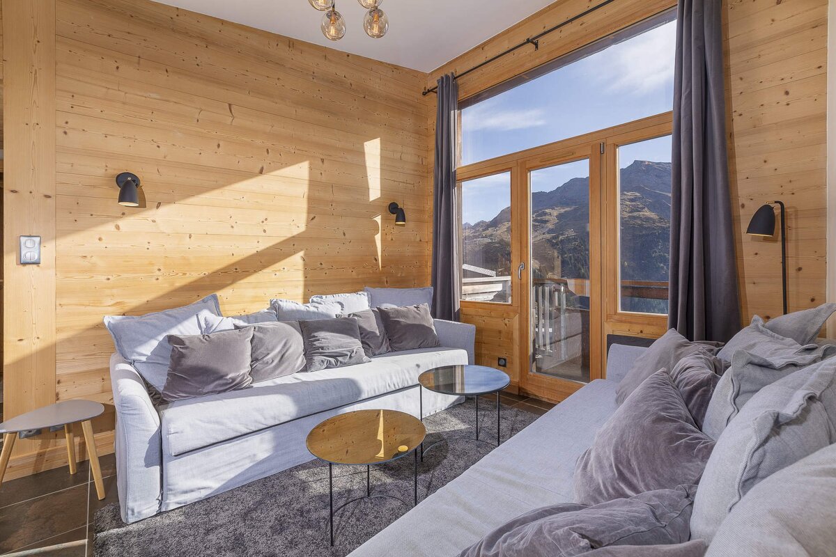 A living room with a couch and two tables