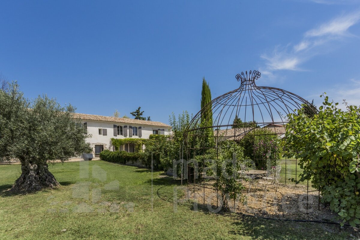A large white house with a gazebo in front of it