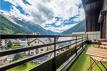A balcony with a view of a mountain range