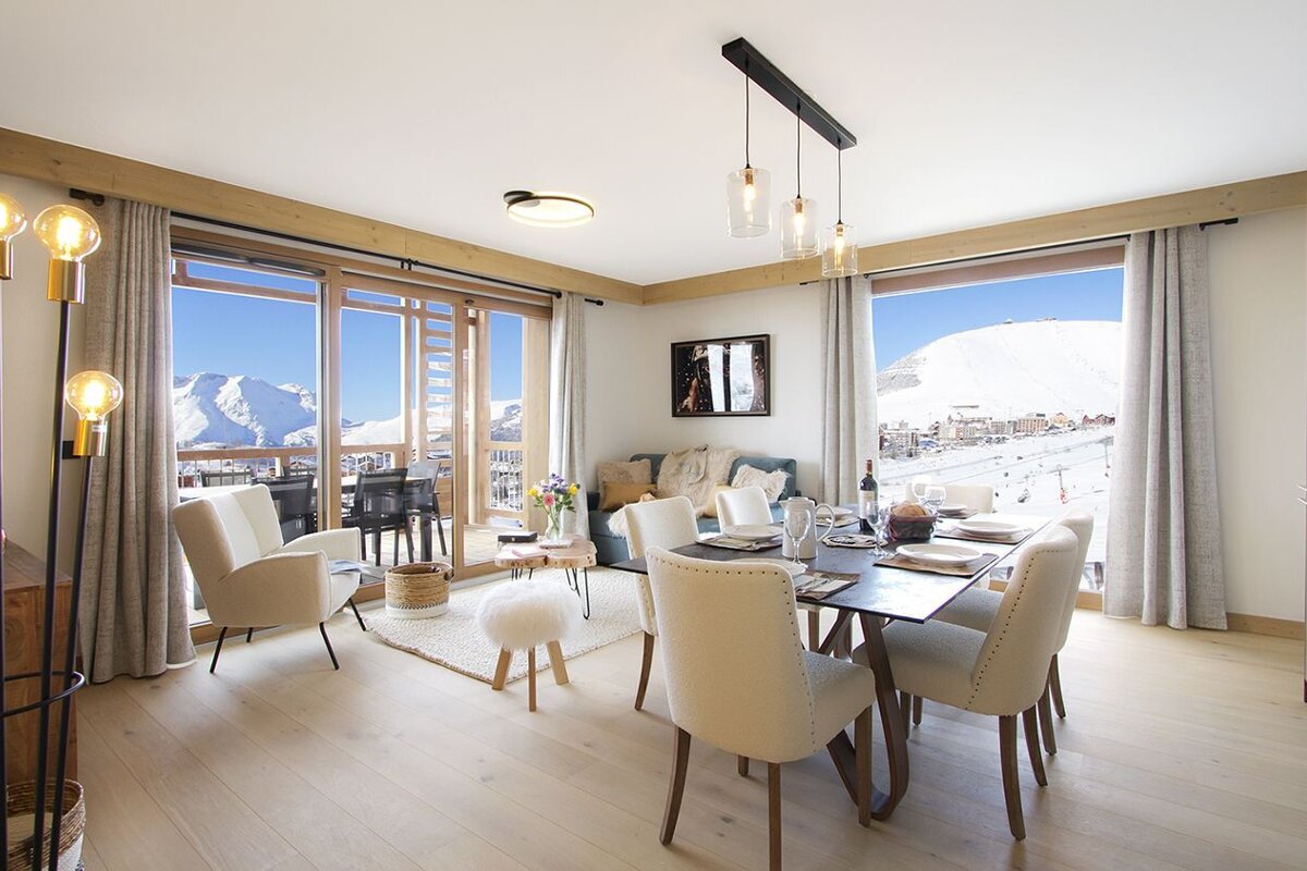 A living room with a dining table and chairs