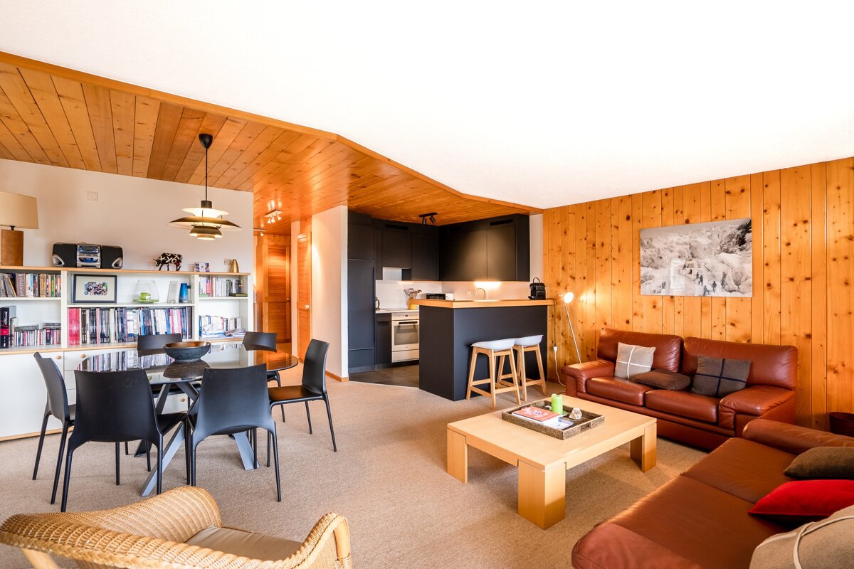 A living room with a couch a table and chairs