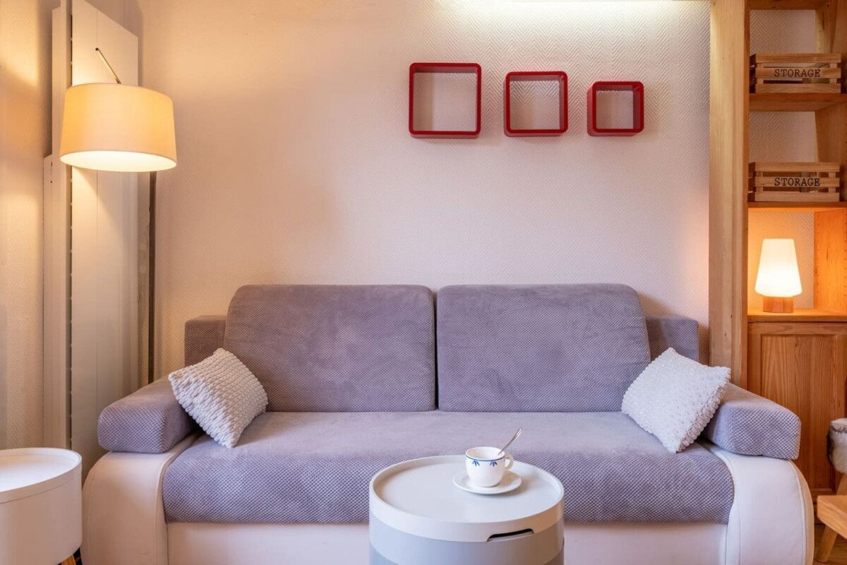 A living room with a couch and a shelf that says storage