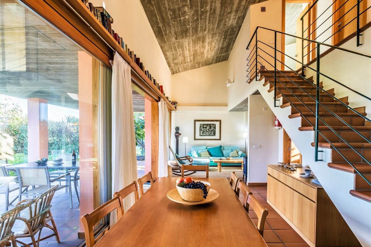 A dining room table with a bowl of grapes on it