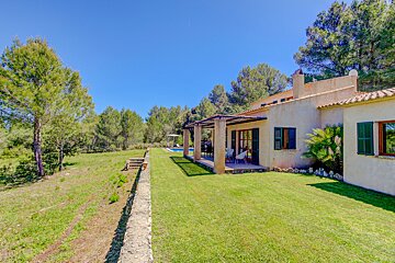 A house with a large lawn in front of it
