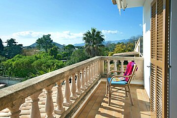 A balcony with a chair and a towel on it