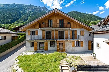 A house with mountains in the background is for sale by frank