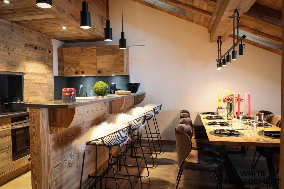 A kitchen with wooden cabinets and a table with candles on it