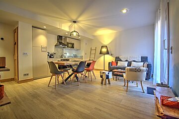 A living room with a couch a table and chairs