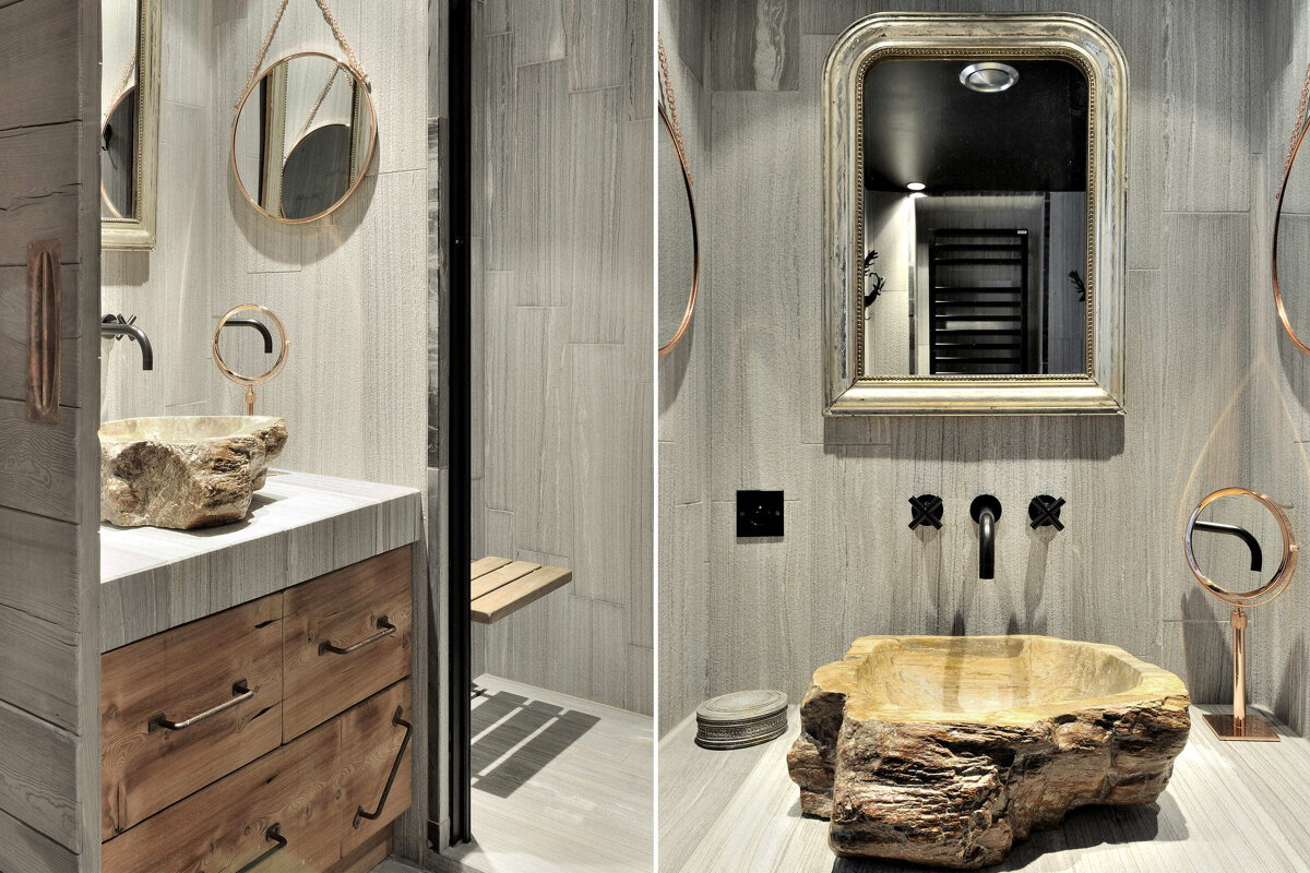 A bathroom with a stone sink and a mirror