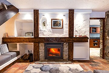 A fireplace with a picture on the wall above it