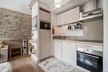 A kitchen with a stove top oven and a microwave