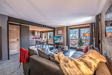 A living room with a couch and a flat screen tv