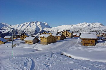 A snowy village with a mountain in the background