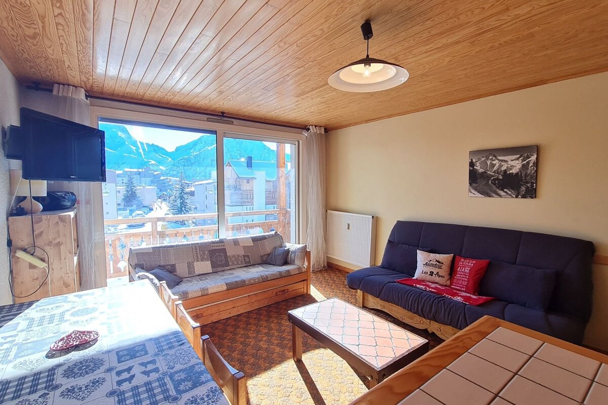A living room with a couch a table and a television