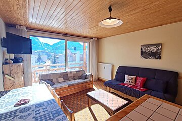 A living room with a couch a table and a television