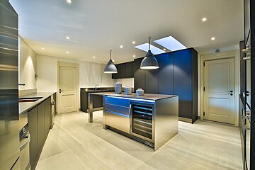 A kitchen with stainless steel cabinets and a wine cooler