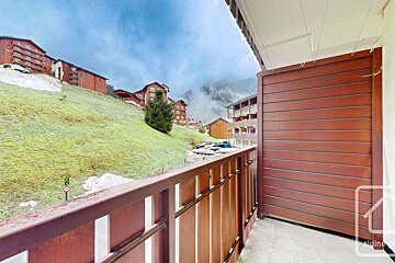 A balcony with a sign that says alpine on it
