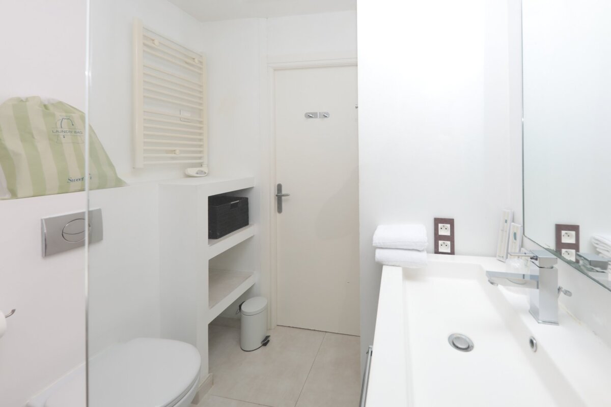 A bathroom with a toilet and a sink and a sign that says ' toilette ' on it