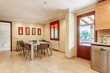A kitchen with a table and chairs and a dishwasher