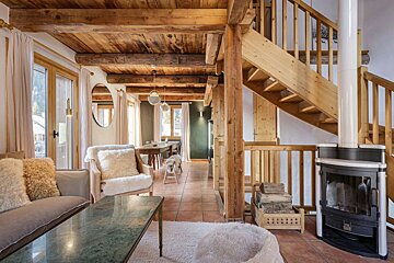 A living room with a staircase leading up to the second floor