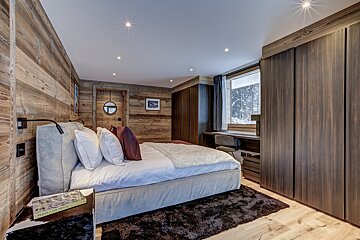 A bedroom with a bed and a book that says happy birthday