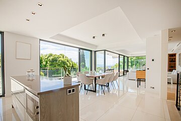 A kitchen with a dining table and chairs in it