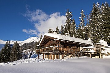 A snowy cabin in the middle of a snowy forest