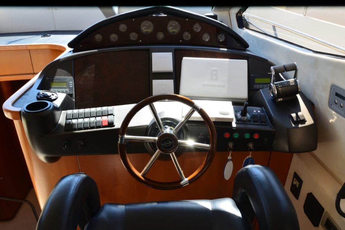 The steering wheel of a boat has a sticker on it that says ' volvo penta '