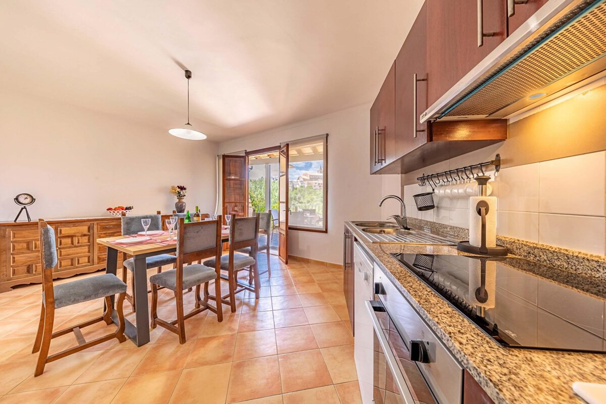 A kitchen with a table and chairs in it