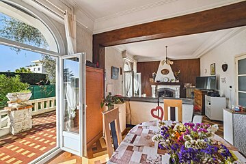 A living room with a fireplace and a table with flowers on it